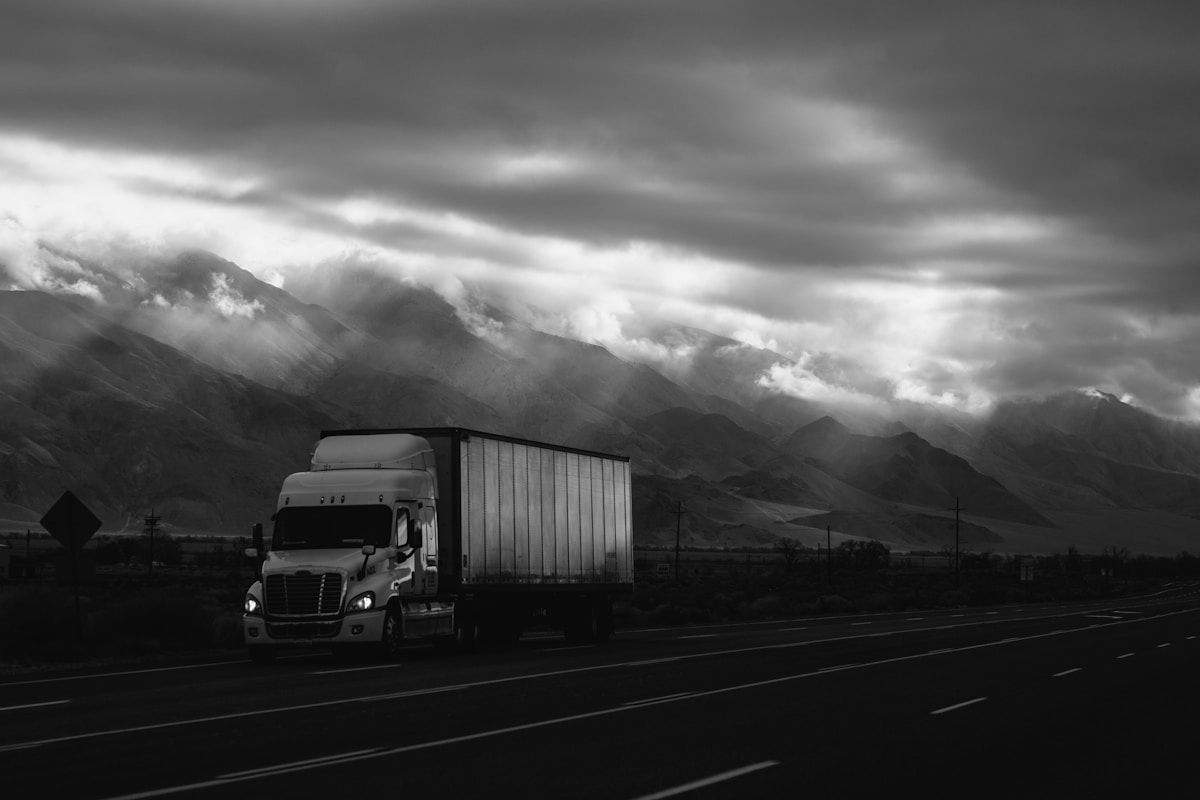 Nordac Trans Inc truck on a mountain highway at dusk